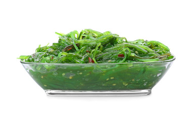 Bowl with tasty seaweed salad on white background