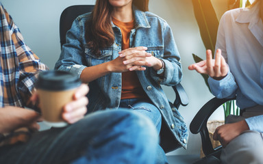 A group of young people sitting and talking together