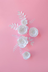 Handmade paper art and cut white flowers on pink background. 