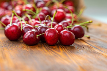 ripe juicy cherries on a wooden table, selective focus