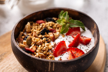 Bowl with granola strawberries and yogurt