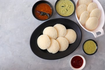 South Indian breakfast dish Idli with Coconut Chutney and sambar. Idly sambar. over light background with copy space.