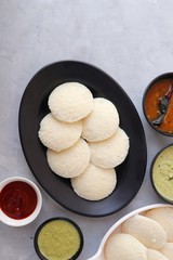 South Indian breakfast dish Idli with Coconut Chutney and sambar. Idly sambar. over light background with copy space.