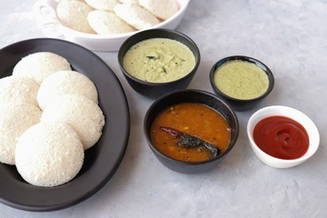 South Indian breakfast dish Idli with Coconut Chutney and sambar. Idly sambar. over light background with copy space.