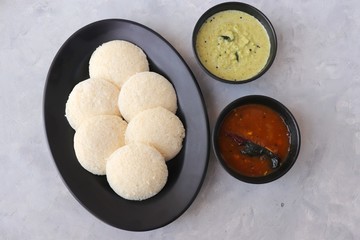 South Indian breakfast dish Idli with Coconut Chutney and sambar. Idly sambar. over light background with copy space.