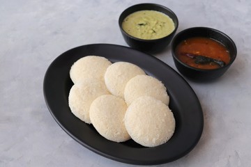 South Indian breakfast dish Idli with Coconut Chutney and sambar. Idly sambar. over light background with copy space.