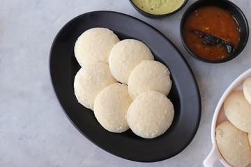 South Indian breakfast dish Idli with Coconut Chutney and sambar. Idly sambar. over light background with copy space.