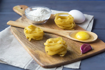 tagliatelle pasta and ingredients for cooking. Italian Cuisine