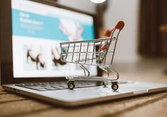 Trolley shopping cart on a computer laptop keyboard. Ideas for shopping online or e-commerce from...