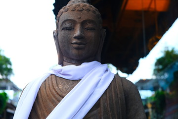 The Buddha smiles at the camera.