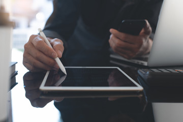 Business man working on computer devices in modern office