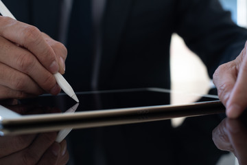 E-signing and electronic signature, businessman signing contract on digital tablet 