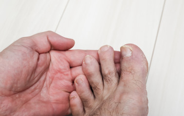 hands of a man lifting his toes