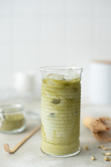 cold green matcha with milk in a tall glass