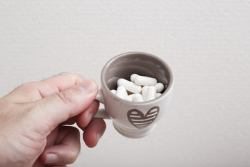 medicines into a coffee cup