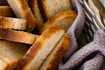 Vanilla crackers for tea, simple sweet crunchy snack in a wicker basket on natural fabric, picnic in nature
