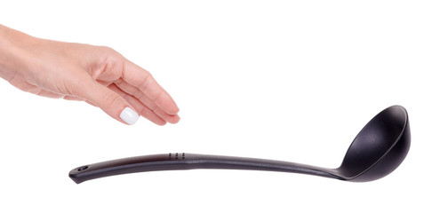 Hand with black plastic ladle, kitchen utensil, isolated on white background.