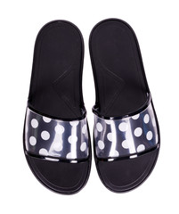 Black slippers with dotted pattern, isolated on white background.