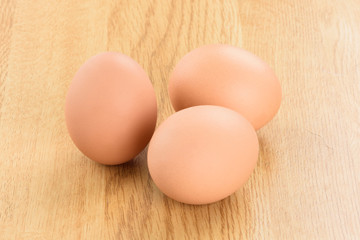 The eggs isolated on the wooden background