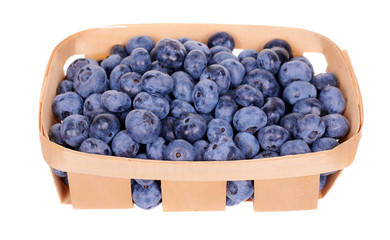 Fresh raw blueberry in wooden basket, isolated on white background.