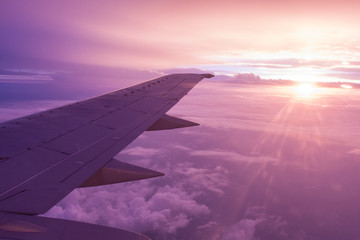 Fototapeta na wymiar View on the sunset from airplane window seat.