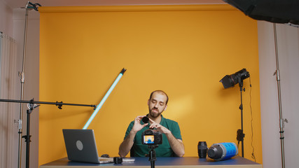 Photography vloger holding round nd filters to the camera while recording video. Variable ND filter...