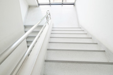 Staircase inside the building. White stairs.