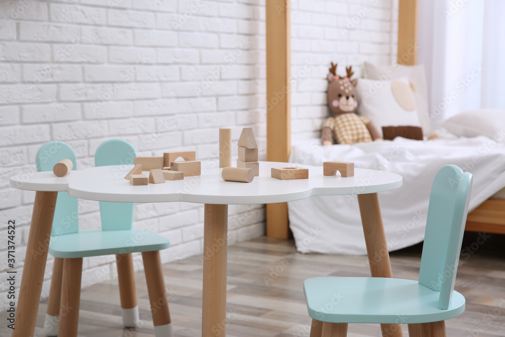 Canvas Prints Little table and chairs with bunny ears in baby room. Interior design