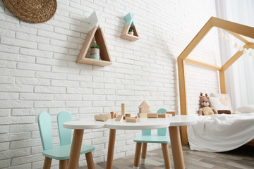 Cute children's room interior with bed and little table