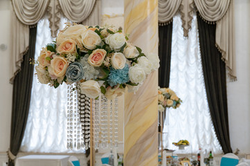 Wedding festive restaurant interior decoration. Floral bouquet indoors. Bohemian style interior.