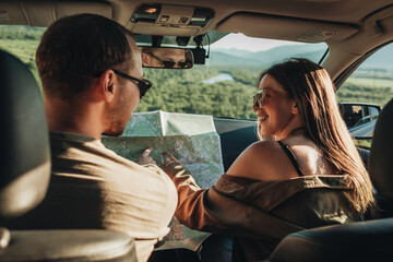 Couple in a Car Going on Roadtrip, Man and Woman Using Map