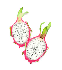 Halves of delicious ripe dragon fruit (pitahaya) on white background, top view