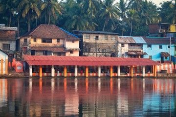 27.12.2019 Gokarna, Karnataka, Colorful indian houses, bright orange-striped temple tank on the bank of sacred lake Koti Teertha. The city is a holy pilgrimage site for Hinduists