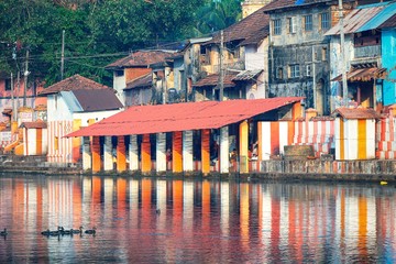 27.12.2019 Gokarna, Karnataka, Colorful indian houses, bright orange-striped temple tank on the bank of sacred lake Koti Teertha. The city is a holy pilgrimage site for Hinduists