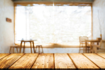 Wooden desk space and blurry background of home window for product display montage.