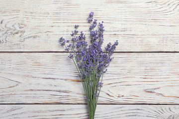 Beautiful fresh lavender flowers on white wooden background, top view