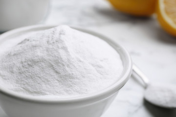 Baking soda on white marble table, closeup