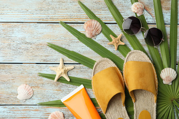 Beach objects on wooden background, flat lay