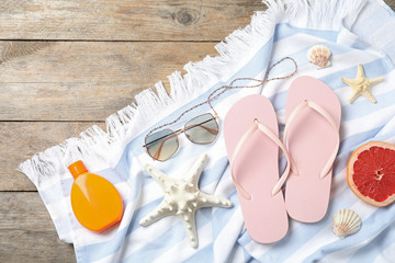 Beach objects on wooden background, flat lay