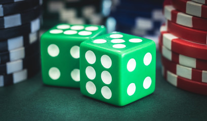 Playing dice and poker chips stacks, close up view