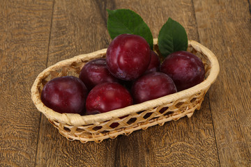 Plum heap in the wooden basket