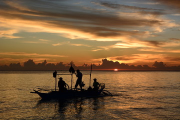 Fishermen silhouettes at sunset. White Beach. Boracay island. Western Visayas. Philippines