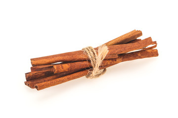 Cinnamon sticks heap isolated on white
