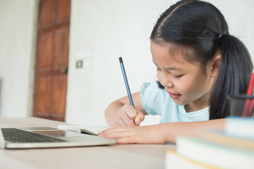 pretty  stylish schoolgirl studying homework during online lesson at home, social distance during quarantine, self-isolation, online education concept, home school, study online video call teacher.