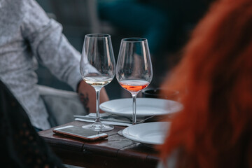 Glasses of white and pink sparkling wine on the table at the restaurant. Special wine tasting.