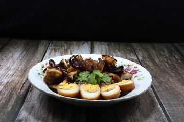 Traditional chopped grilled fresh squid (octopus) and cutting boiled egg topping on cooked jasmine rice. Famous rice street food menu in Asia. Comfort food concept.