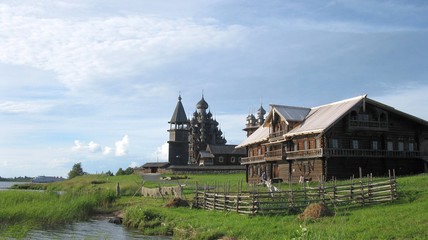 Fototapeta na wymiar an ancient church and the hut of a peasant 