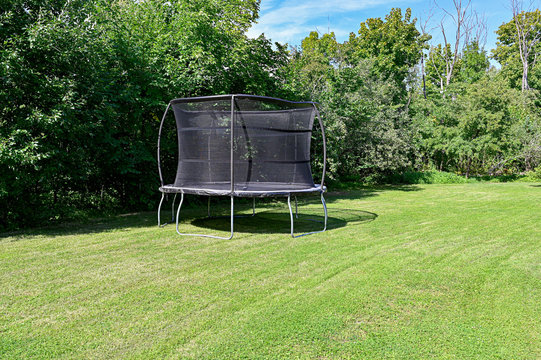 Big Trampoline In A Green Back Garden