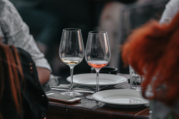 Glass of white sparkling wine at a summer tasting in the hand of a model.