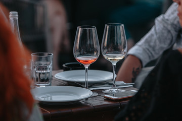 Glass of white sparkling wine at a summer tasting in the hand of a model.